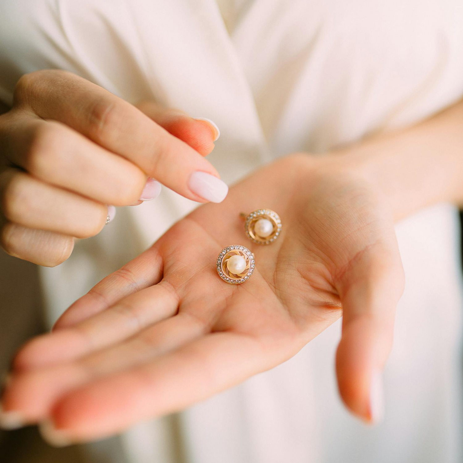 Womens Hand with Pearl Earrings for Care Guide page